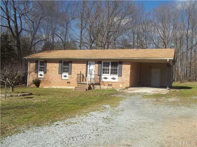 3261 Virgilina Road Roxboro, NC 27574 - Photo 2 of 9 a front view of a house with garden