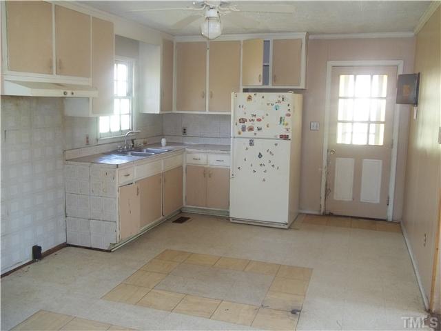 3261 Virgilina Road Roxboro, NC 27574 - Photo 4 of 9 a kitchen with cabinets appliances and a window