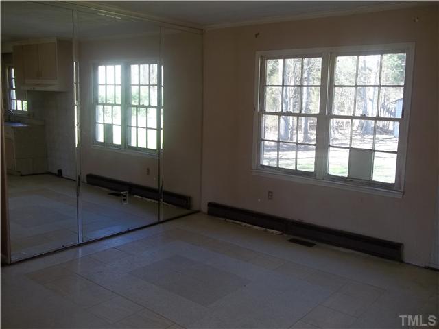 3261 Virgilina Road Roxboro, NC 27574 - Photo 5 of 9 an empty room with windows