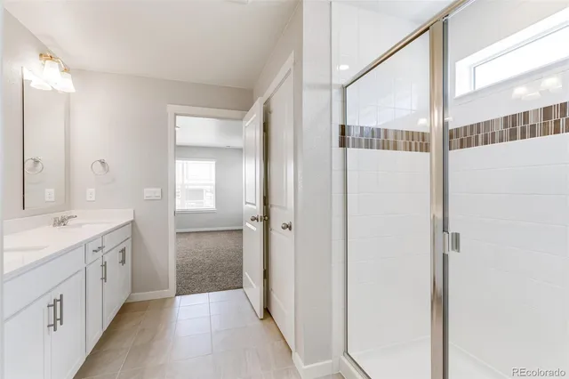 a bathroom with a double vanity sink and mirror