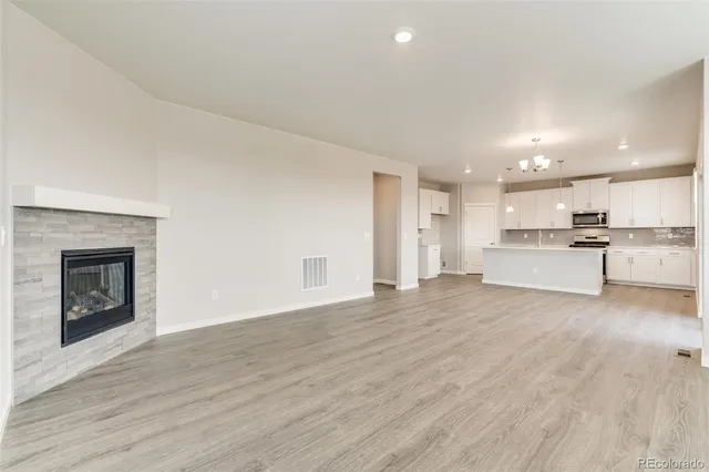 a view of kitchen with wooden floor and electronic appliances