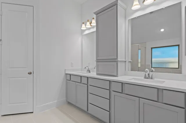 a bathroom with a double vanity sink and mirror