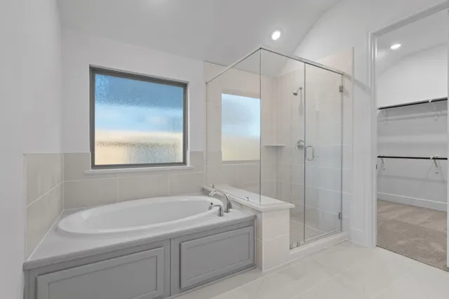 a white bath tub sitting next to a shower