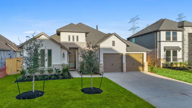 a front view of a house with a garden and plants