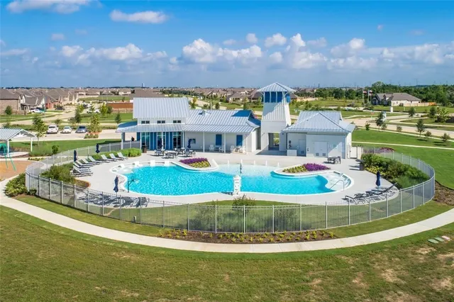 a view of a house with a big yard and large trees