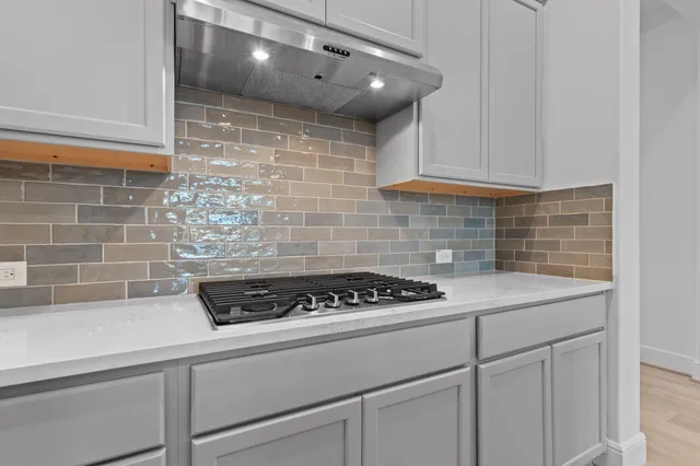 a kitchen with a sink and cabinets