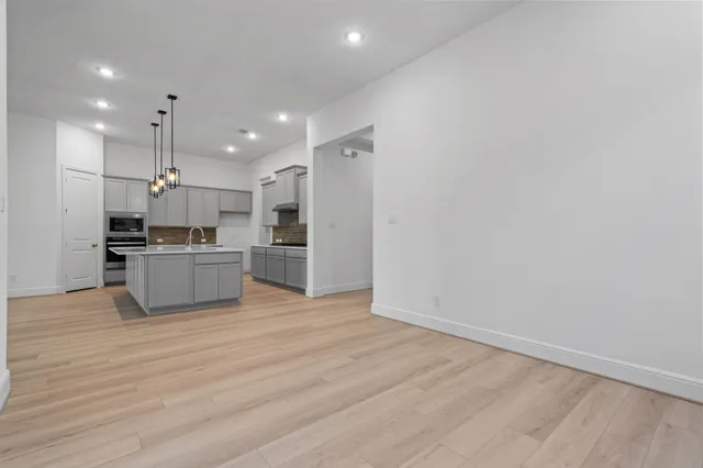 a kitchen with kitchen island white cabinets and stainless steel appliances