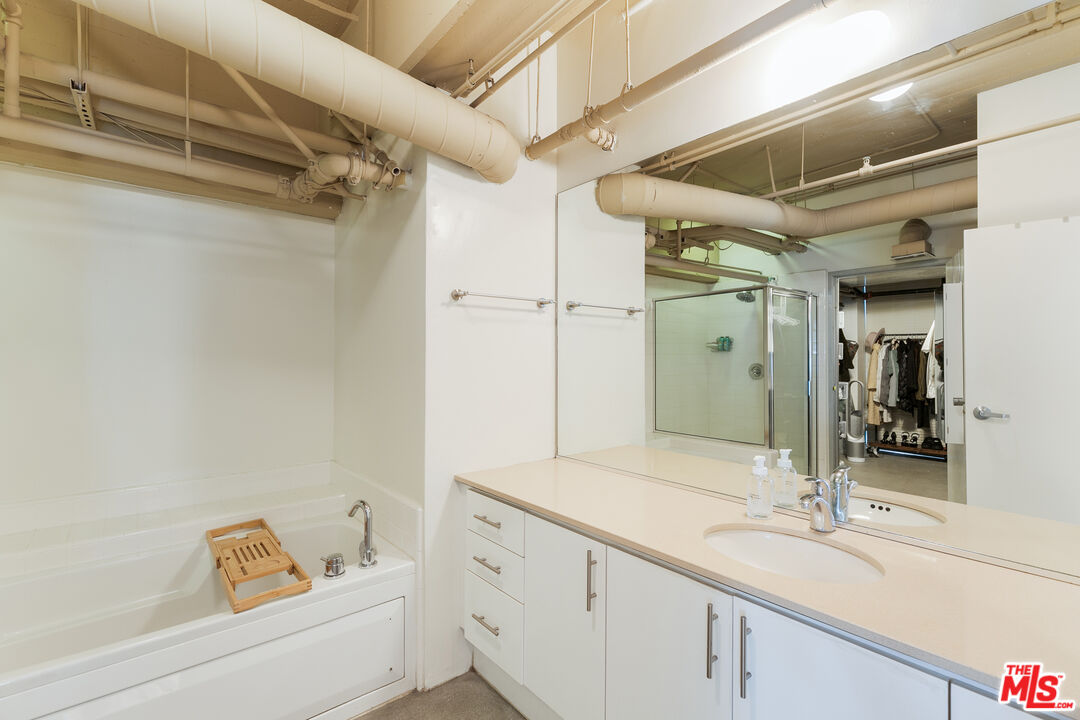 1130 Flower Street, Unit 103 Los Angeles, CA 90015 - Photo 17 of 23 a bathroom with a tub sink and mirror