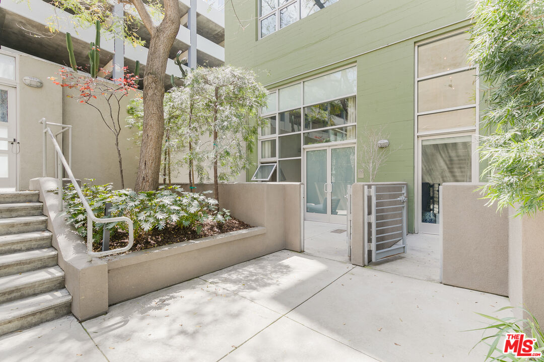 1130 Flower Street, Unit 103 Los Angeles, CA 90015 - Photo 21 of 23 a view of a garden filled with potted plants