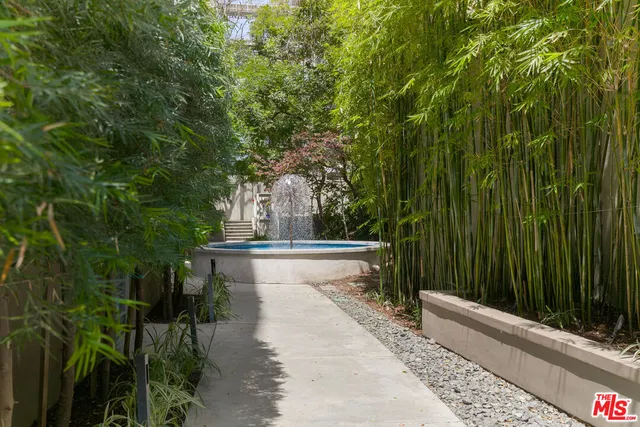 a view of a fountain in the backyard of a house