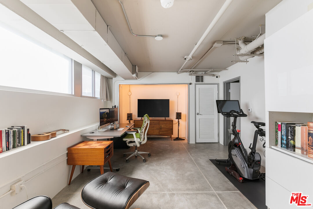1130 Flower Street, Unit 103 Los Angeles, CA 90015 - Photo 7 of 23 a living room with furniture and a flat screen tv