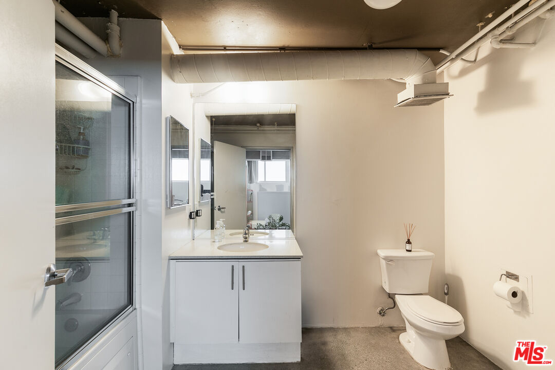 1130 Flower Street, Unit 103 Los Angeles, CA 90015 - Photo 9 of 23 a bathroom with a sink a toilet and shower
