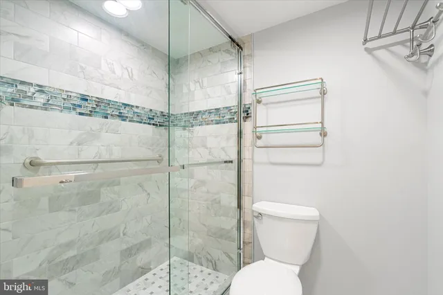 a bathroom with a toilet and a shower