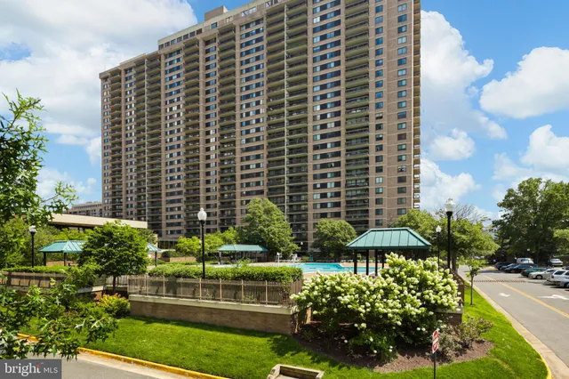 a view of a city from a balcony with furniture