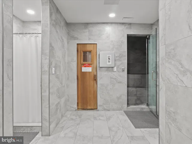 a bathroom with a shower and a sink