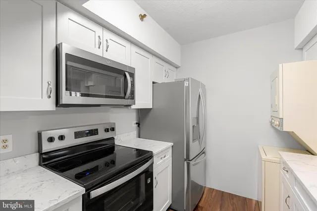 a kitchen with stainless steel appliances a stove a microwave and a refrigerator