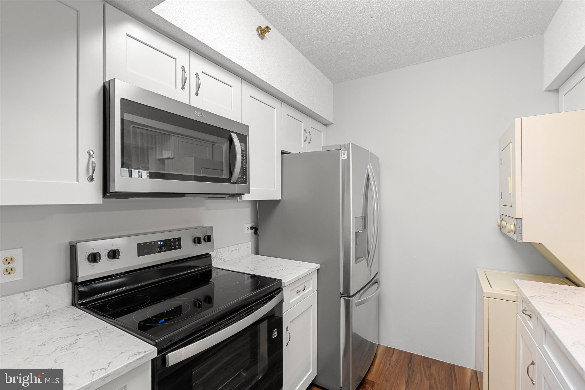5505 Seminary Road, Unit 408N Falls Church, VA 22041 - Photo 3 of 31 a kitchen with stainless steel appliances a stove a microwave and a refrigerator