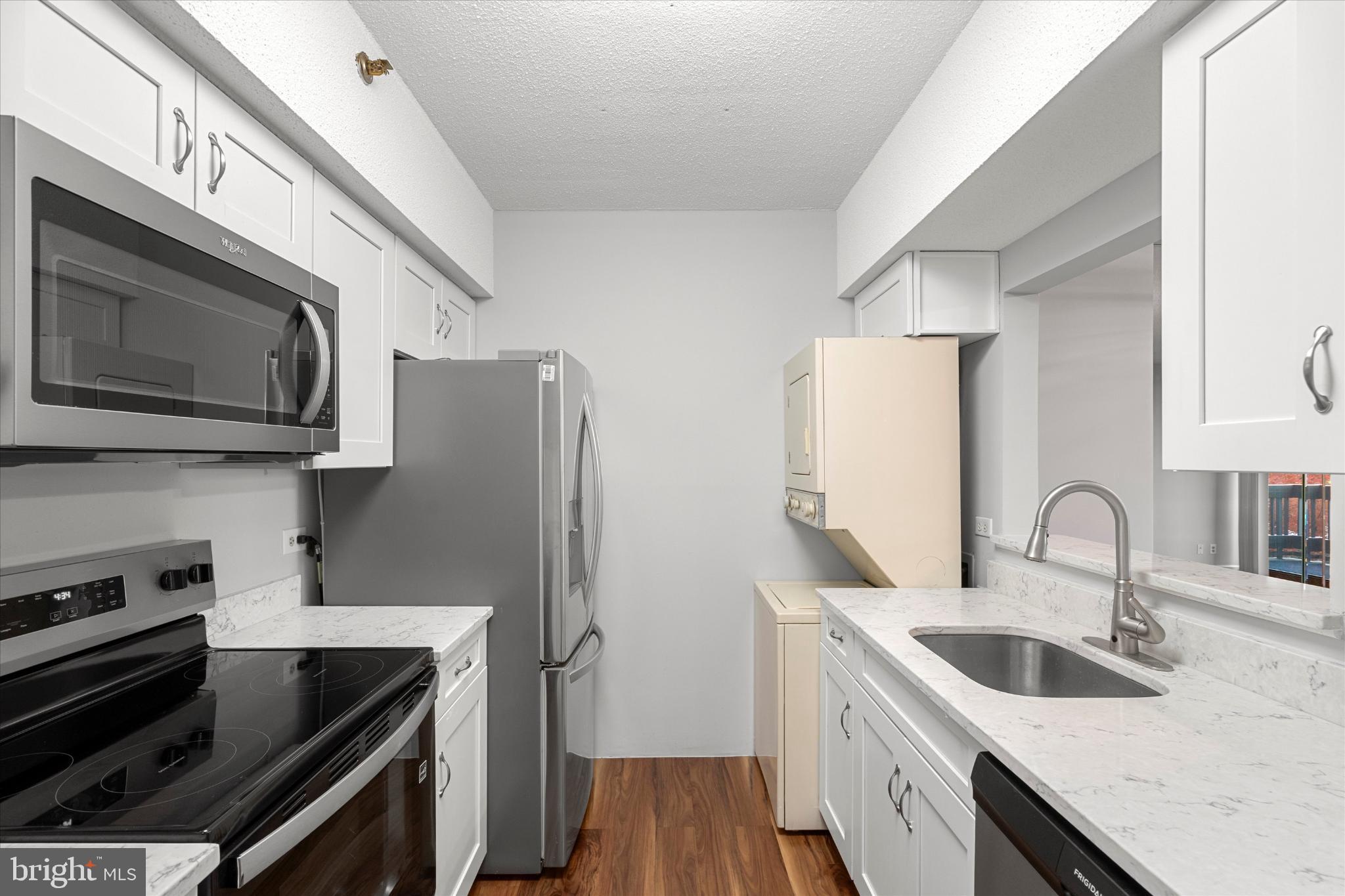 5505 Seminary Road, Unit 408N Falls Church, VA 22041 - Photo 4 of 31 a kitchen with stainless steel appliances granite countertop a sink stove and microwave