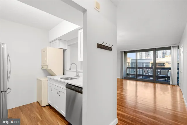 a kitchen with a wooden floor and a large window