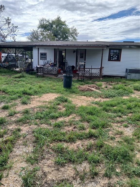 a view of a house with a yard and sitting area