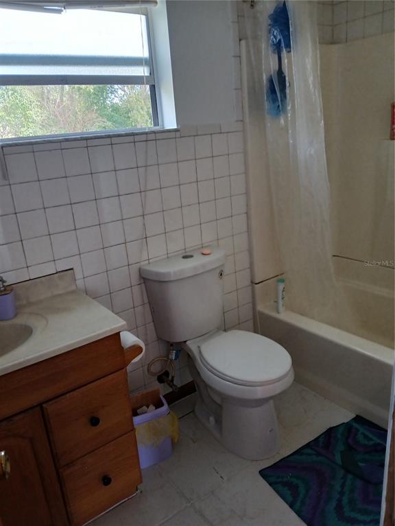 171 Melhorn Road Haines City, FL 33844 - Photo 9 of 13 a bathroom with a toilet a sink and a window