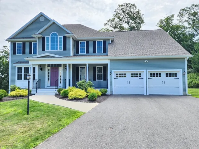 a front view of a house with a yard and porch