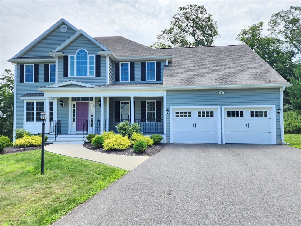 a front view of a house with a yard and porch