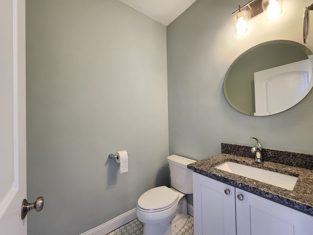 16 Exeter Road Hudson, MA 01749 - Photo 16 of 42 a bathroom with a granite countertop sink and a mirror