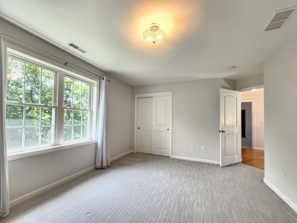 16 Exeter Road Hudson, MA 01749 - Photo 26 of 42 a view of an empty room with a window and wooden floor