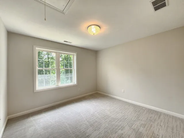 an empty room with a empty space and a window