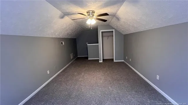 a view of a livingroom with a ceiling fan and window