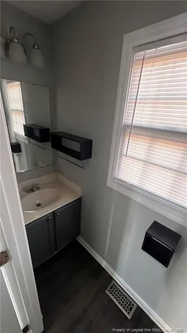 a bathroom with a sink and a window