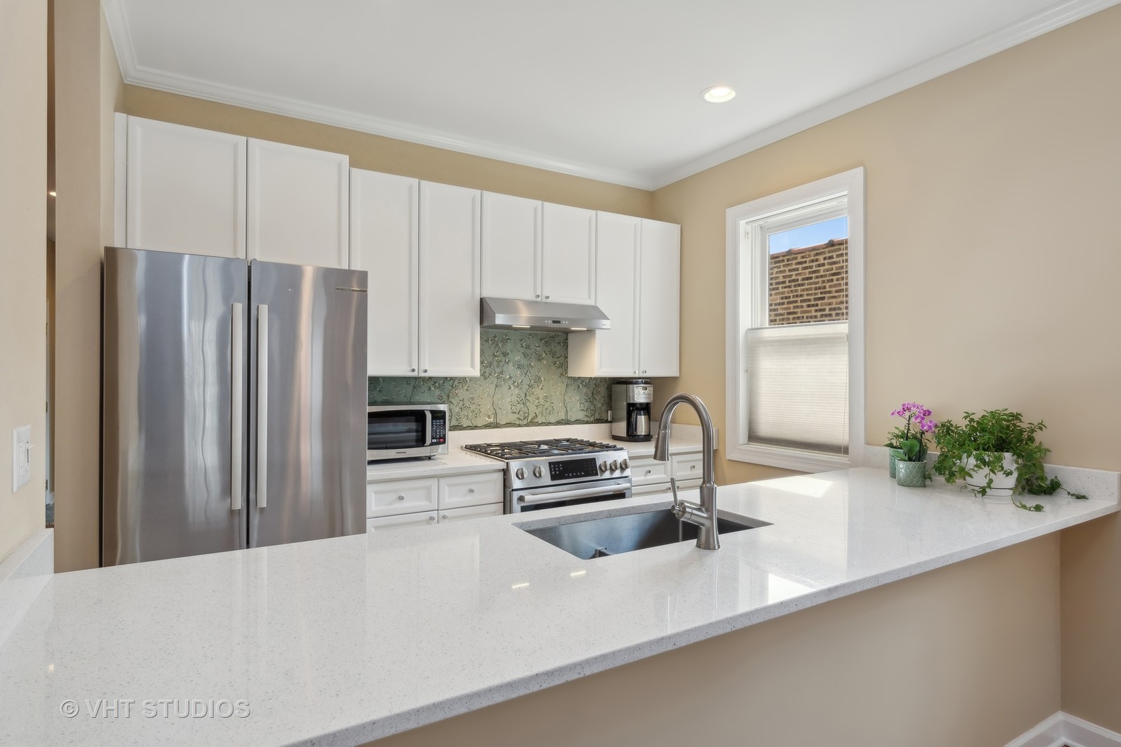 1725 North Mohawk Street, Unit 2S Chicago, IL 60614 - Photo 5 of 15 a kitchen with kitchen island a sink stainless steel appliances and cabinets