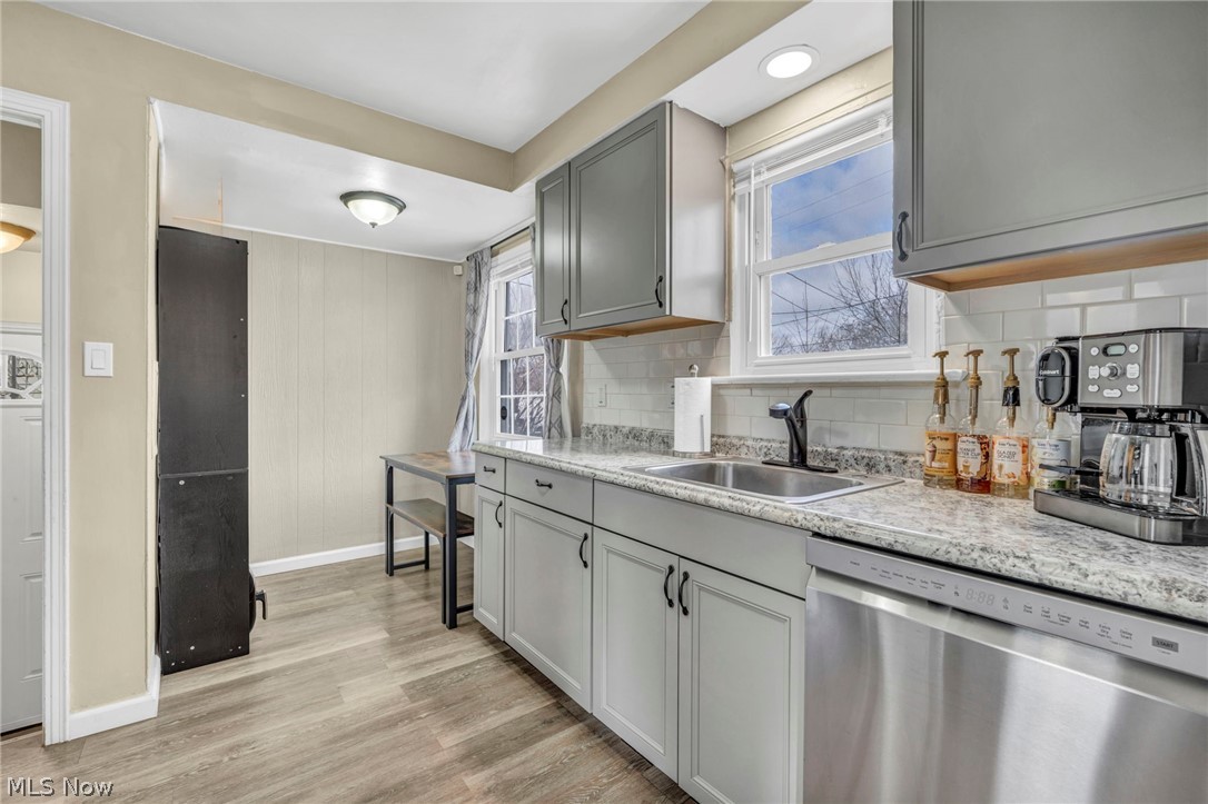 12821 Havana Road Cleveland, OH 44125 - Photo 15 of 41 Kitchen with sink, gray cabinets, light hardwood / wood-style floors, dishwasher, and backsplash