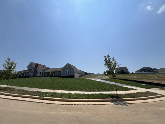 an empty room with windows and fireplace