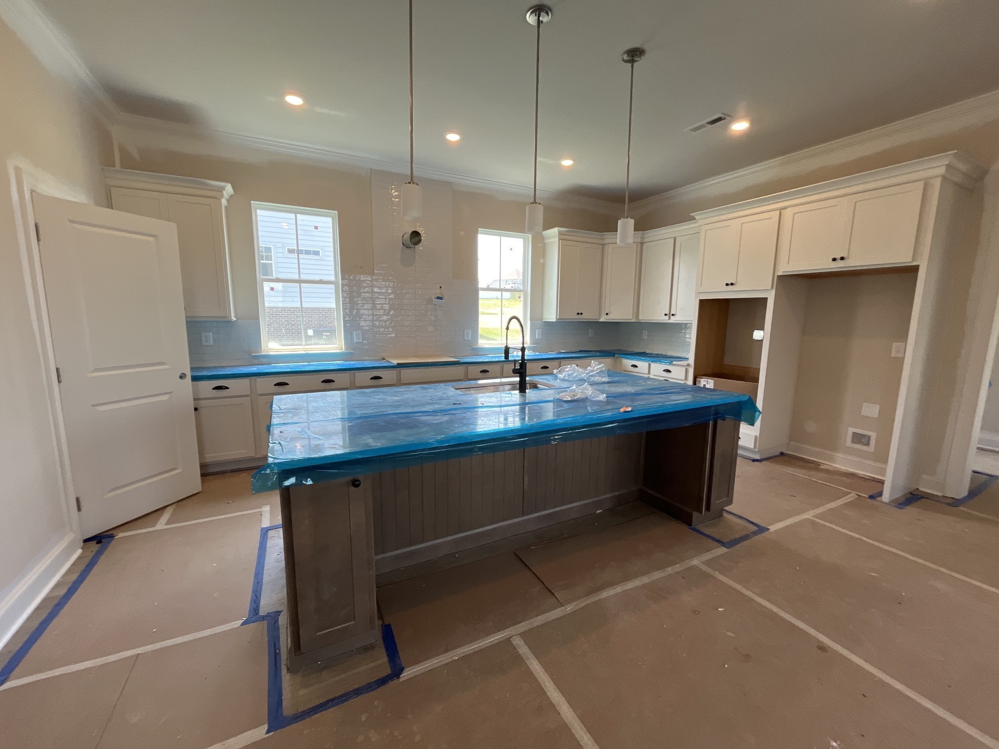 7509 Shoal Mill Point Fairview, TN 37062 - Photo 9 of 29 a kitchen with a refrigerator a sink and chairs