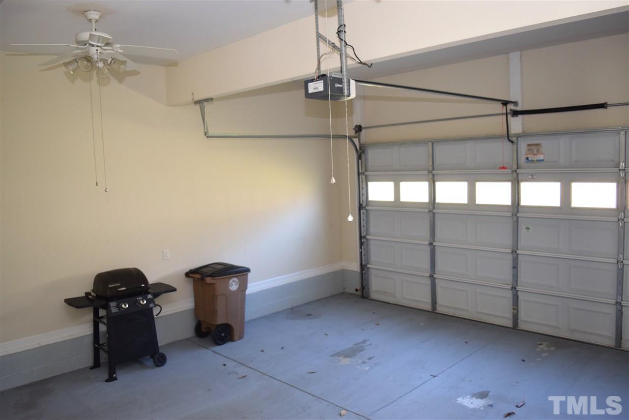 620 Middle Bridge Road Wake Forest, NC 27587 - Photo 22 of 25 Finished Garage has closet for yard tools and ceiling fans to keep you cool if you wanted to have a workshop area.