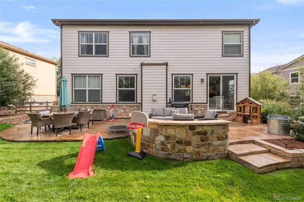 a front view of house with yard and outdoor seating