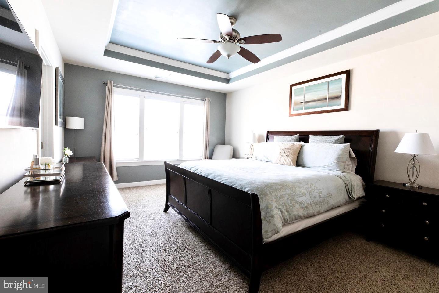 409 Hydrangea Place Gaithersburg, MD 20878 - Photo 22 of 49 a spacious bedroom with a bed and a chandelier