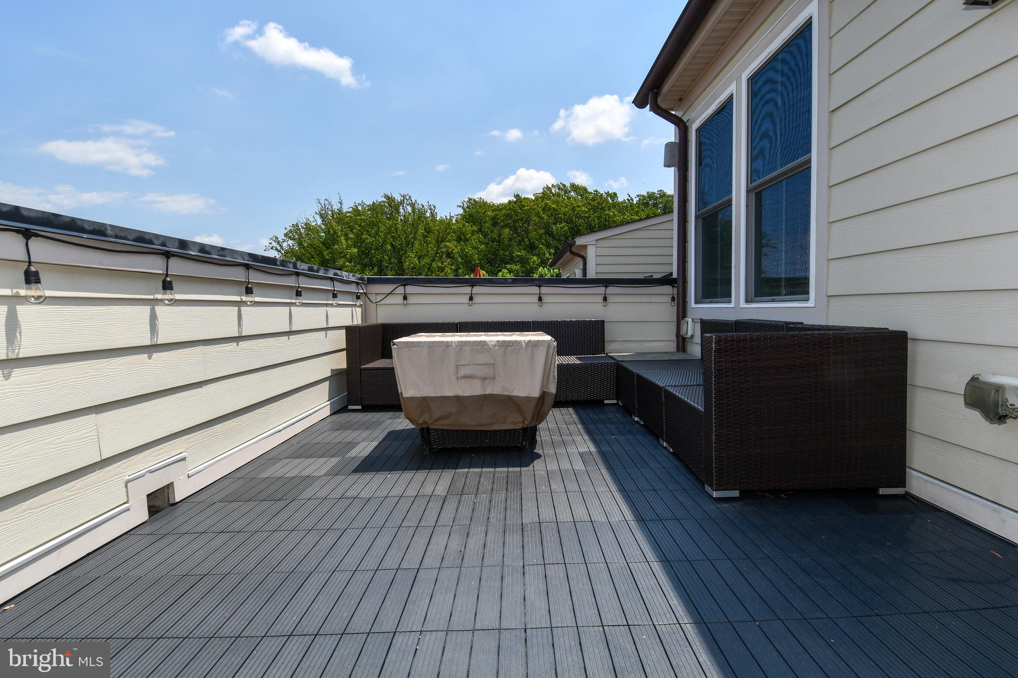 409 Hydrangea Place Gaithersburg, MD 20878 - Photo 42 of 49 a balcony with wooden floor and outdoor seating