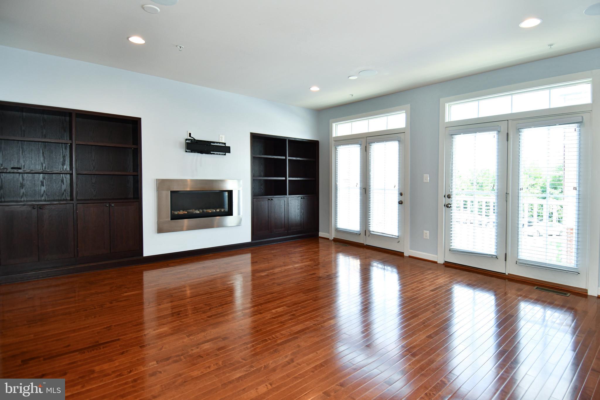 409 Hydrangea Place Gaithersburg, MD 20878 - Photo 9 of 49 a view of empty room with wooden floor and fireplace