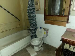 3224 Baylor Street Lubbock, TX 79415 - Photo 13 of 23 a bathroom with a toilet a sink and a bath tub