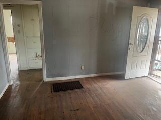 3224 Baylor Street Lubbock, TX 79415 - Photo 3 of 23 an empty room with wooden floor and mirror