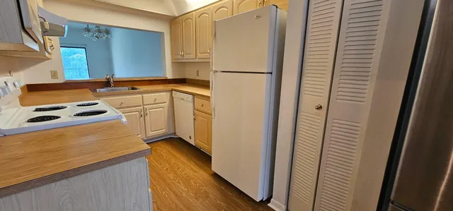 a kitchen with a refrigerator and a stove