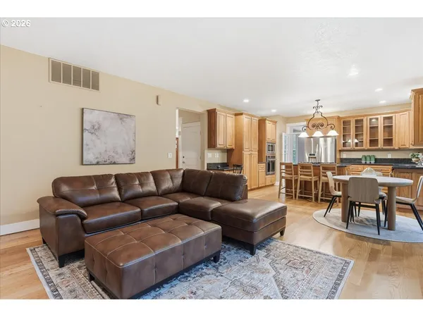 a living room with furniture and a view of kitchen