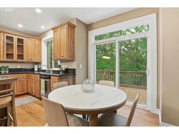a kitchen with a table chairs sink and cabinets