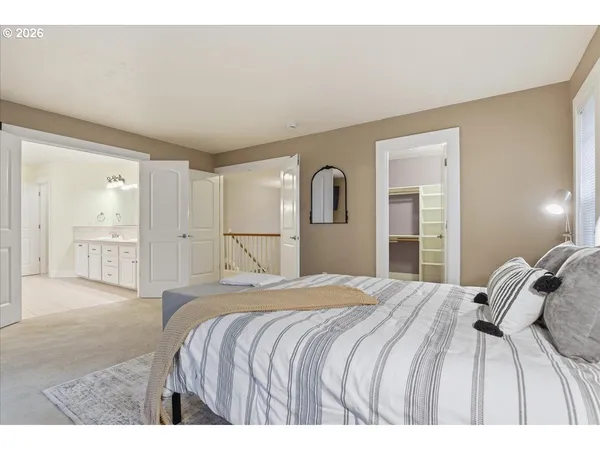 a bedroom with a bed and a lamp