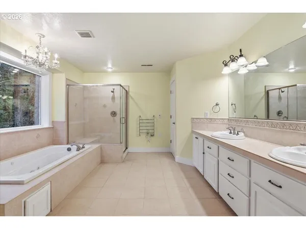 a spacious bathroom with a double vanity sink mirror and double