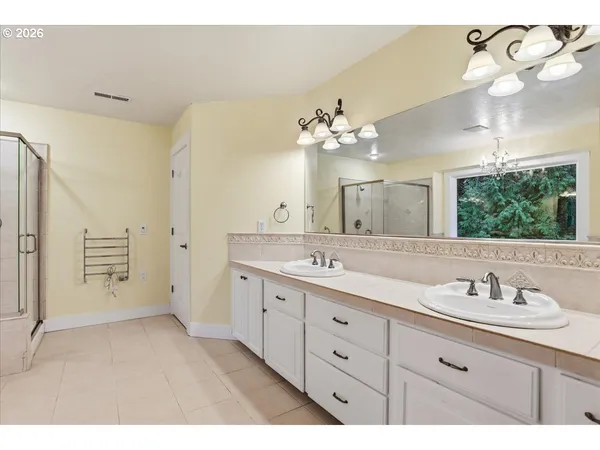 a spacious bathroom with a double vanity sink double and mirror