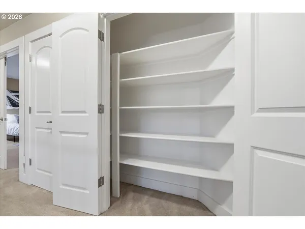 a view of walk in closet with empty racks